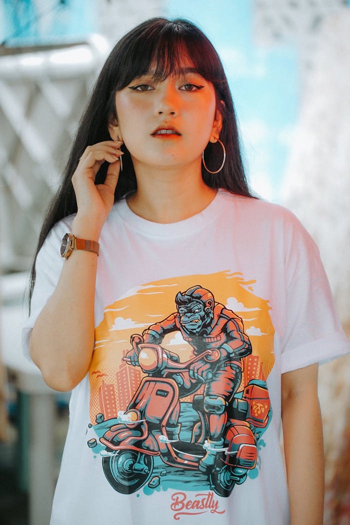 Chic fashion portrait of a young woman in a trendy graphic T-shirt, posing confidently.